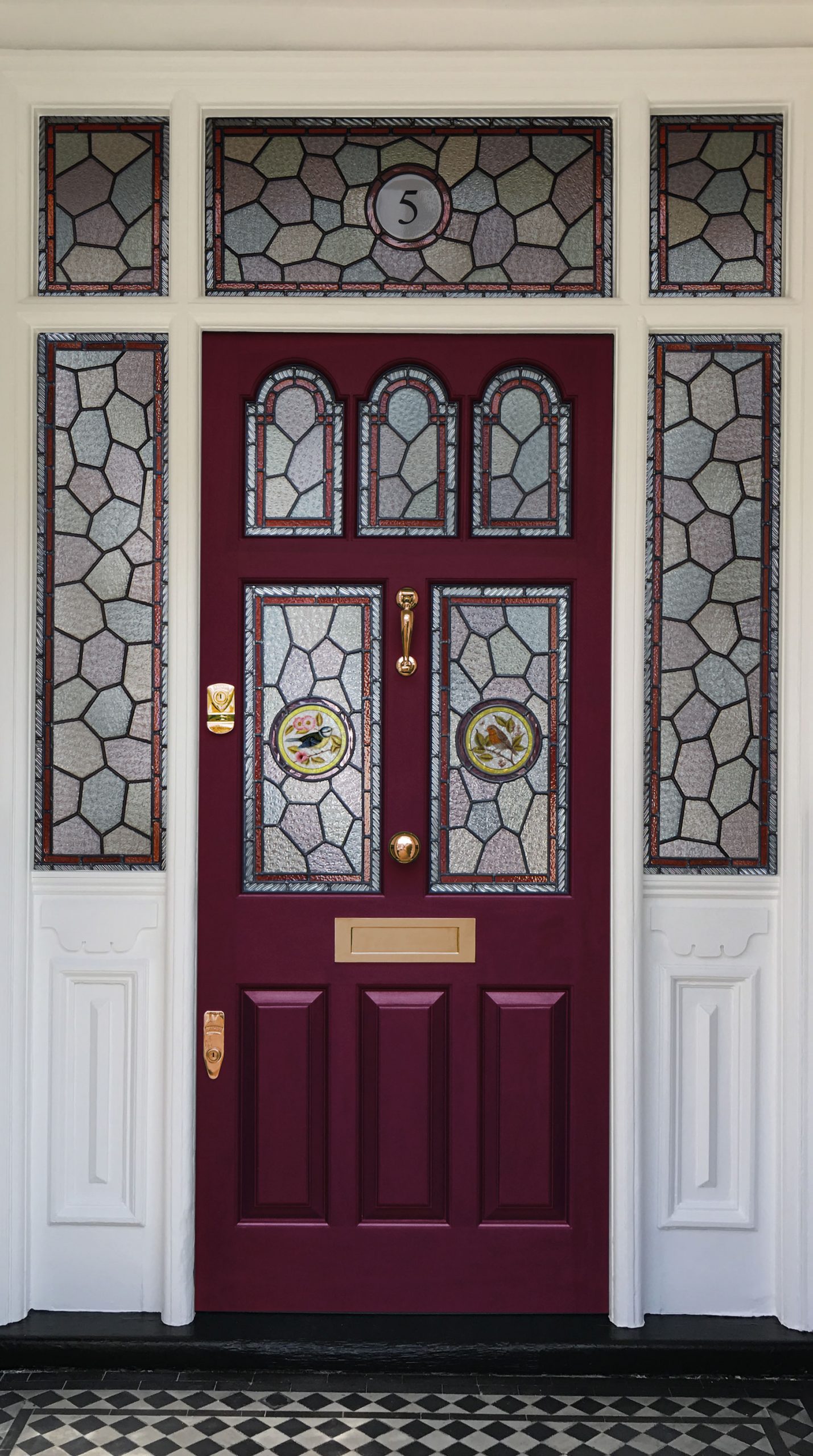 Dark red door in our Mulberry shade, with stained glass panels and brass hardware.