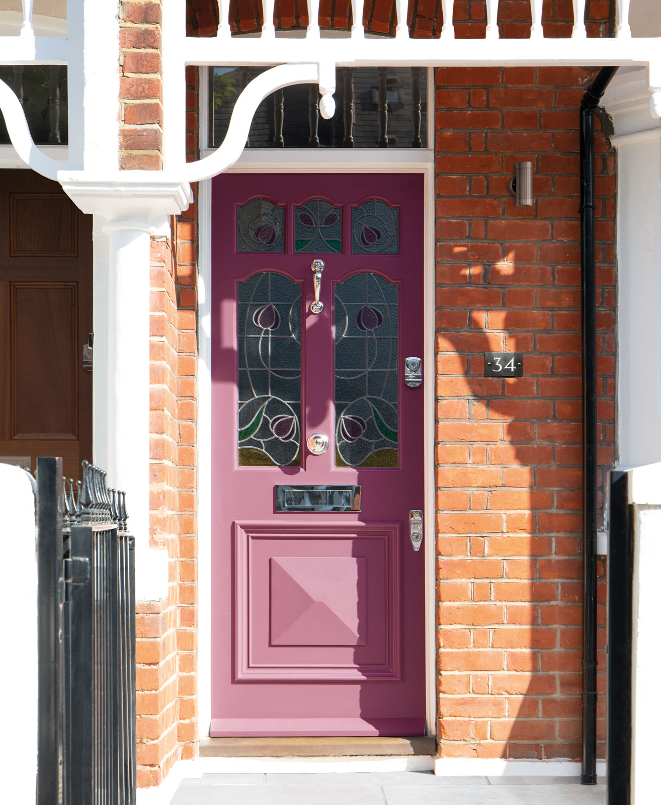 Dark pink Victorian door with stained glass